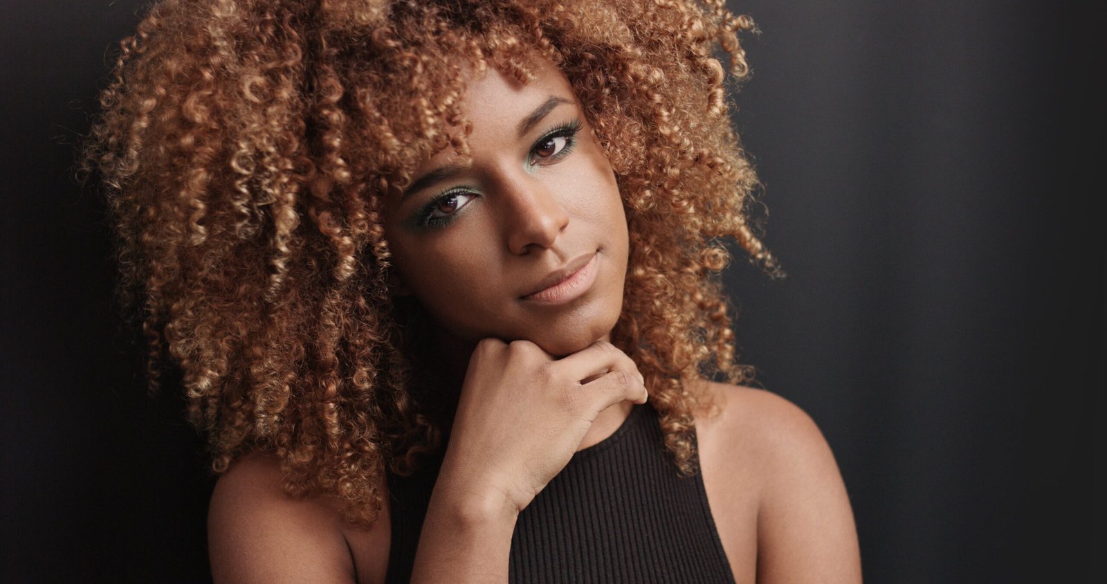 Pretty black girl with big hair posing video on black background